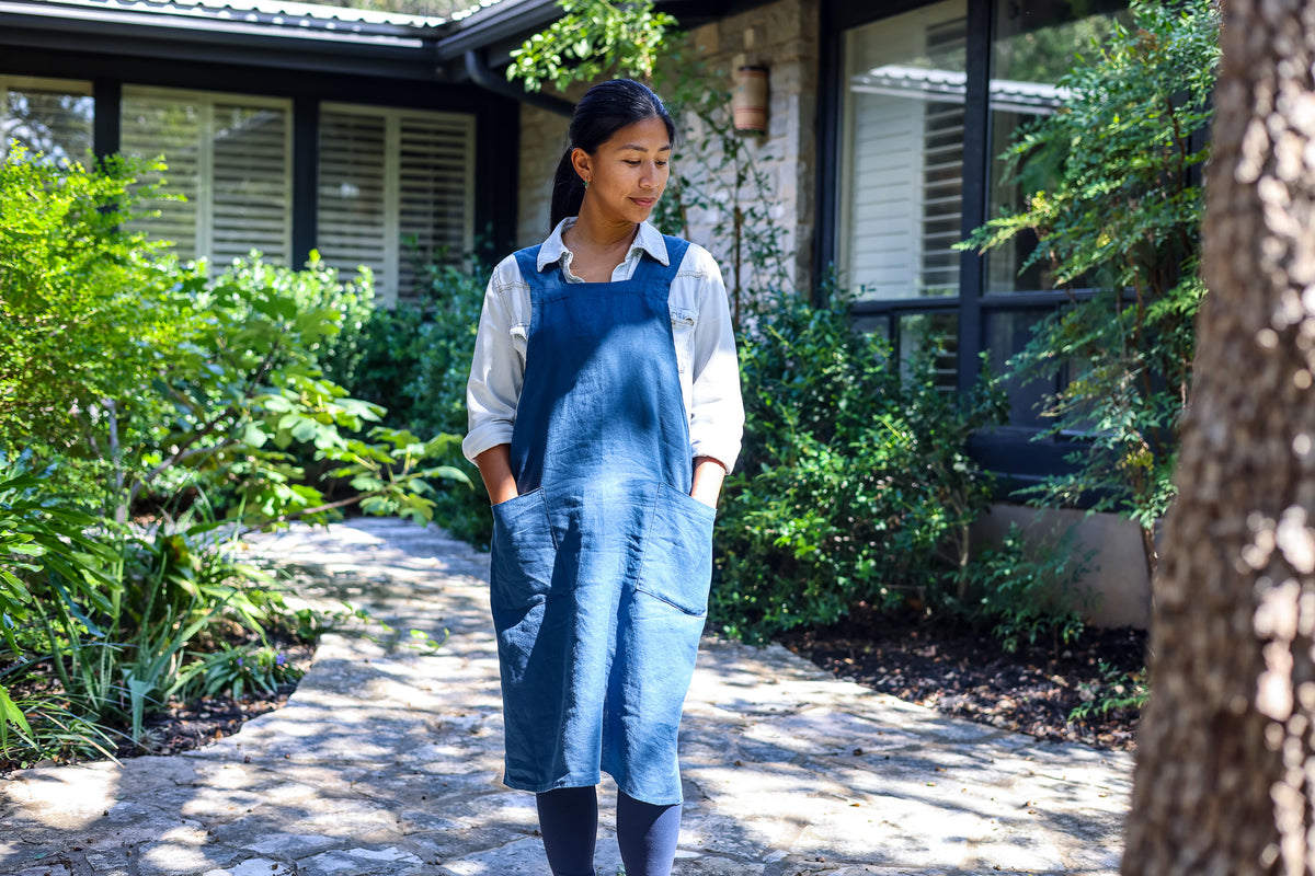 Model wearing the Blue cross-back linen apron
