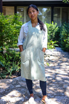 Model wearing the Green Stripe cross-back linen apron