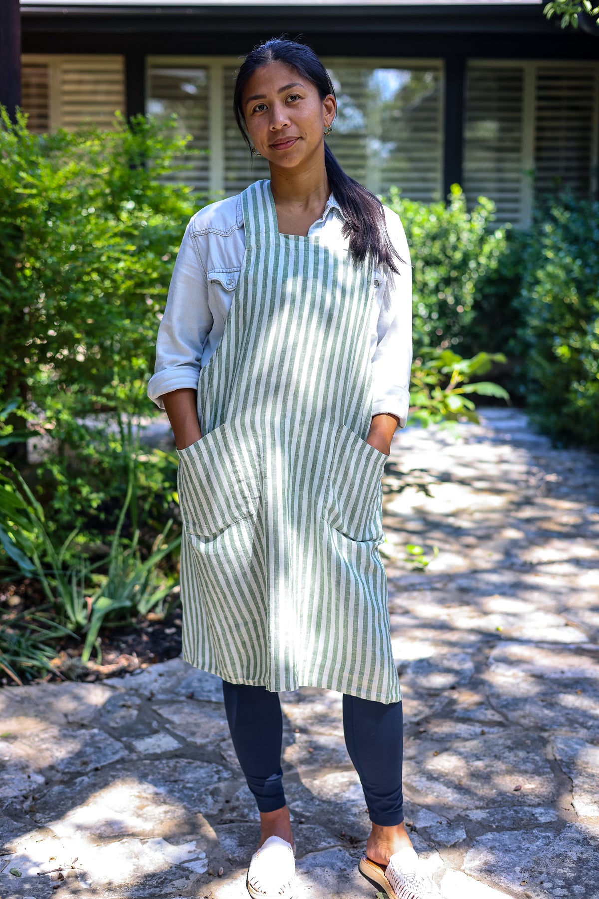 Model wearing the Green Stripe cross-back linen apron