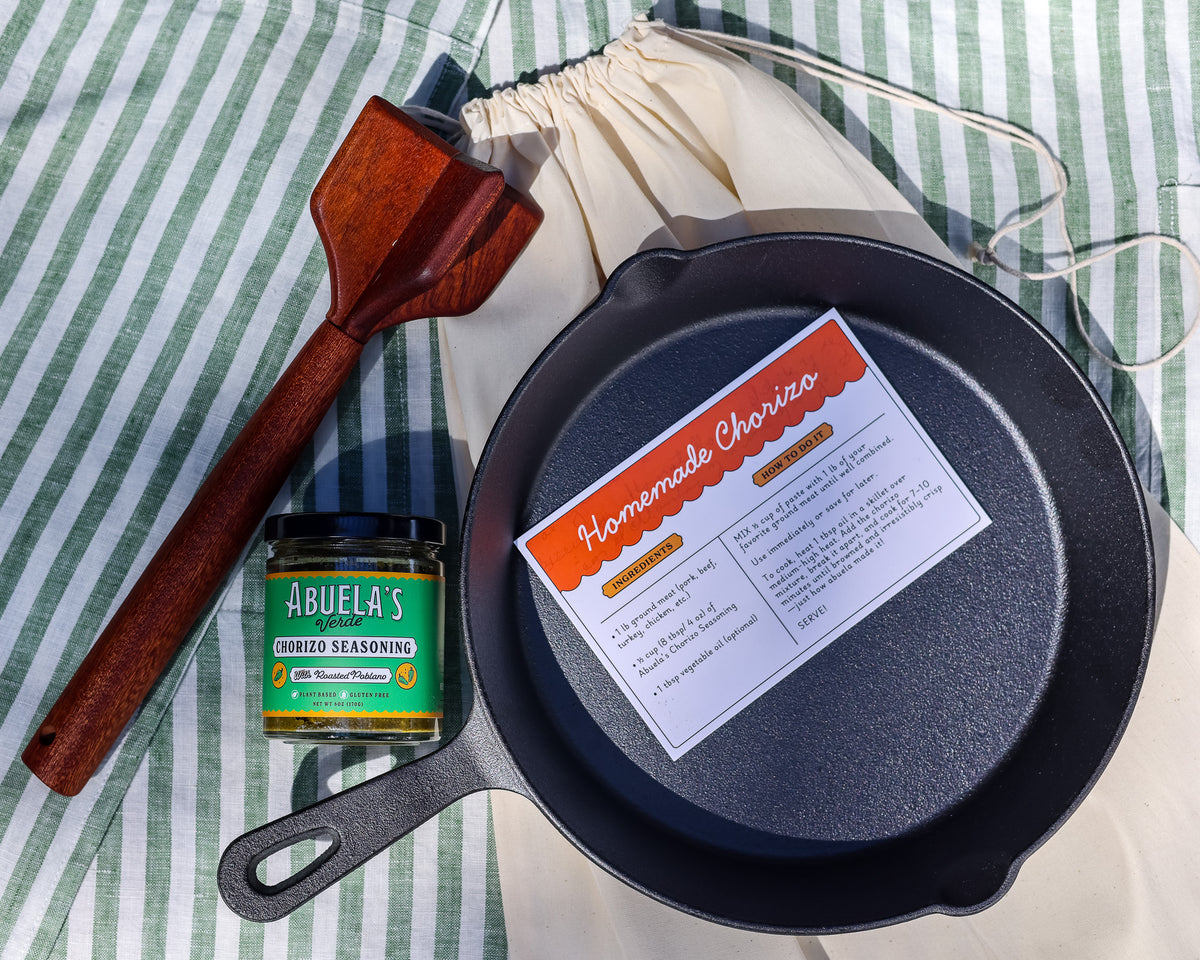 Overhead view of the chorizo kit with Verde seasoning, skillet, recipe card, teak chopper and Green Stripe apron
