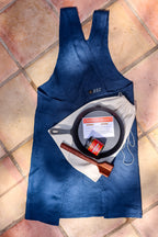 Chorizo kit with Spanish chorizo seasoning, skillet, teak chopper and blue linen apron on terracotta tile