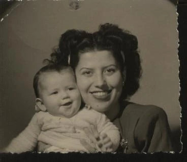 Vintage black and white photo of a woman holding a baby
