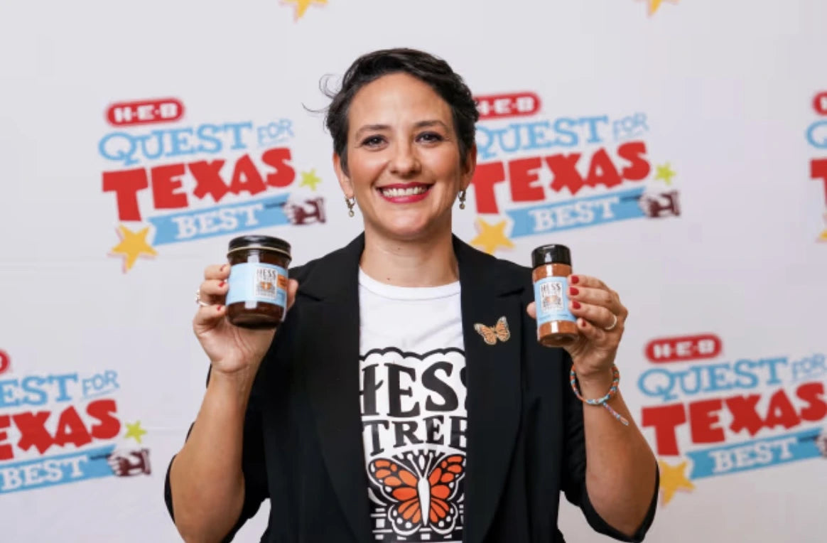 Person holding two jars with a 'Quest for Texas Best' backdrop